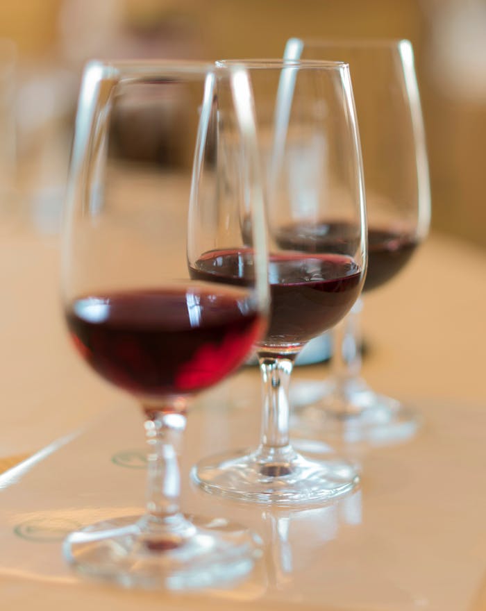 Close-up of red wine glasses in an elegant French setting, perfect for wine tasting experiences.